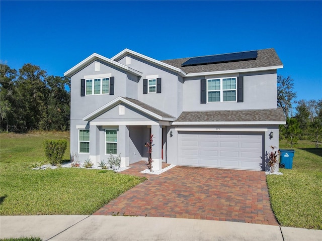 view of front facade featuring solar panels, a garage, and a front lawn