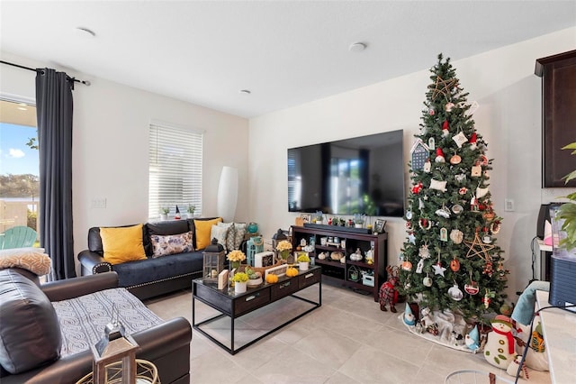 living room with light tile patterned floors and plenty of natural light