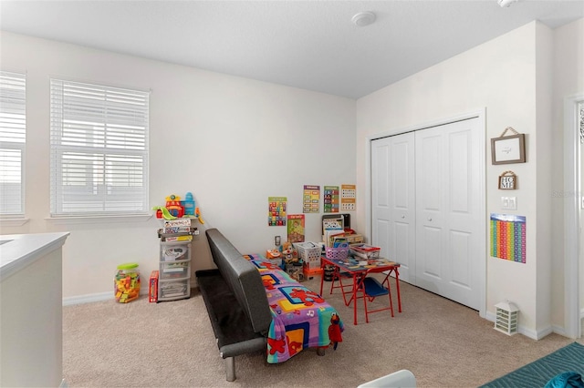 recreation room featuring light carpet