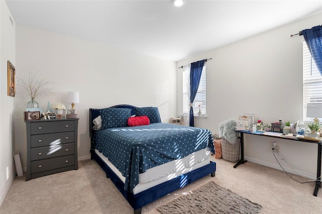 bedroom featuring light colored carpet