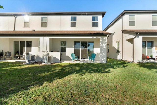 rear view of property featuring ac unit, a yard, a patio area, and central air condition unit