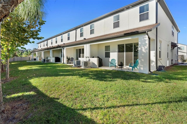 back of property featuring ac unit, a yard, and a patio