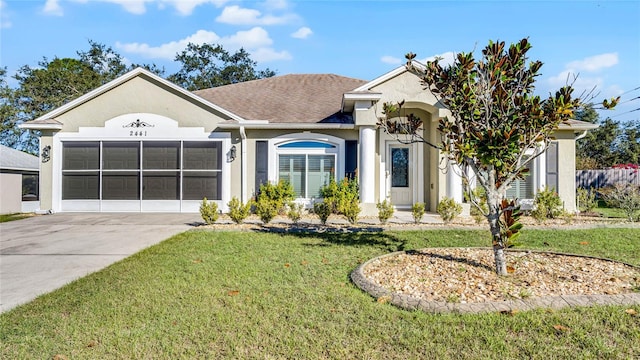 ranch-style home with an attached garage, a shingled roof, concrete driveway, stucco siding, and a front yard