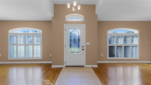 entryway featuring a notable chandelier and light hardwood / wood-style floors