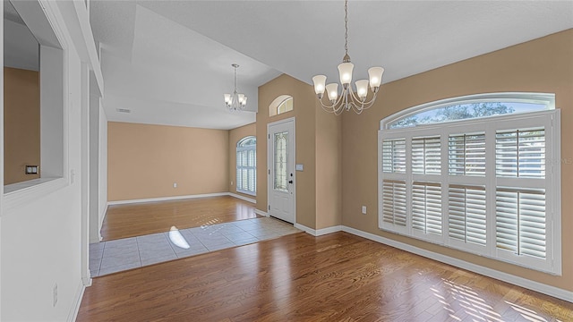 entryway featuring a notable chandelier and light hardwood / wood-style flooring