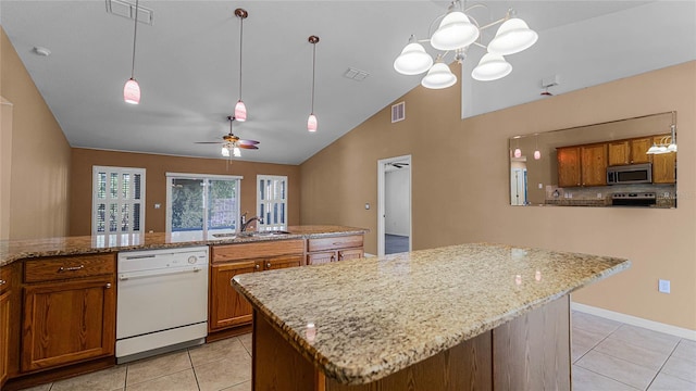 kitchen with ceiling fan with notable chandelier, stainless steel appliances, pendant lighting, high vaulted ceiling, and light tile patterned flooring