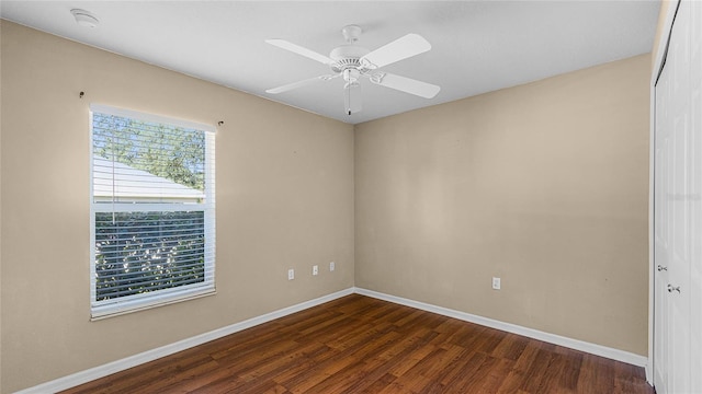 unfurnished room with ceiling fan and dark hardwood / wood-style flooring