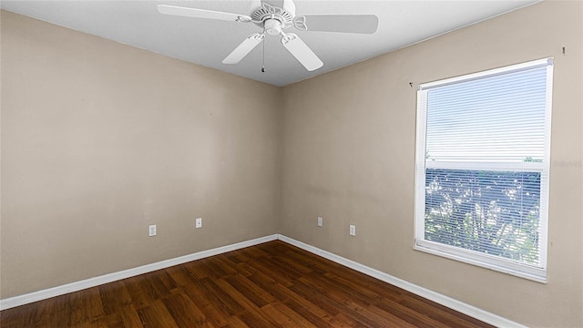 spare room featuring dark hardwood / wood-style flooring and ceiling fan