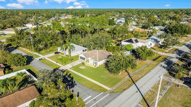 drone / aerial view with a forest view and a residential view