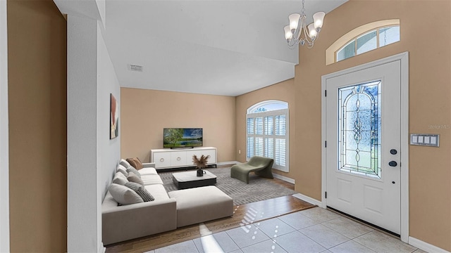 2441 Derby Dr, Deltona, FL 32738 - entrance foyer with light tile patterned floors, baseboards, visible vents, and an inviting chandelier