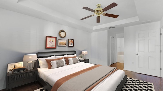 2441 Derby Dr, Deltona, FL 32738 - bedroom with a ceiling fan, visible vents, a raised ceiling, and wood finished floors