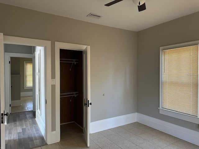 tiled empty room with ceiling fan