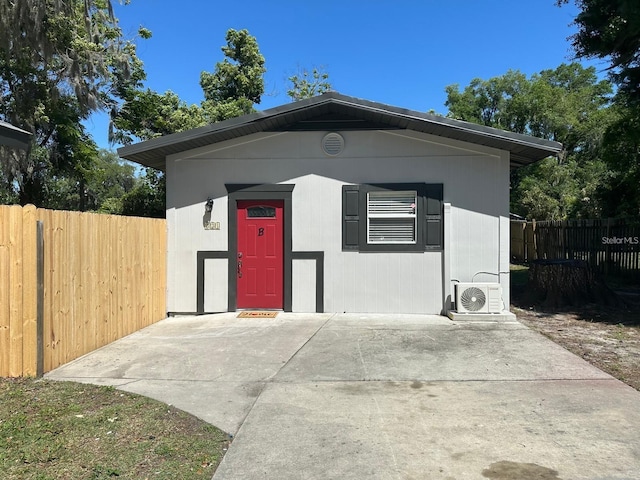 exterior space with ac unit and a patio