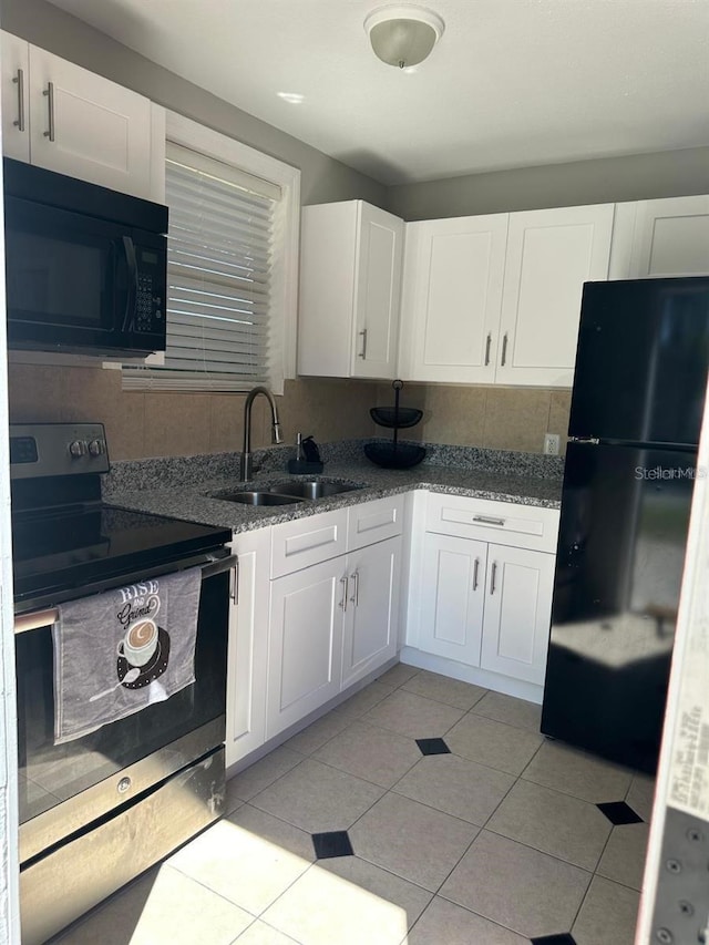 kitchen with black appliances, white cabinets, and sink