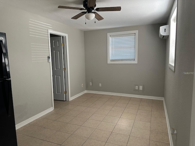 tiled spare room with a wall mounted air conditioner and ceiling fan