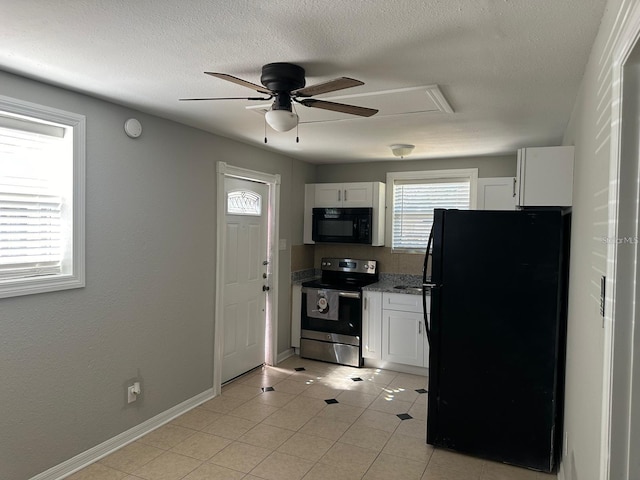 kitchen featuring white cabinetry, ceiling fan, light stone counters, light tile patterned flooring, and black appliances