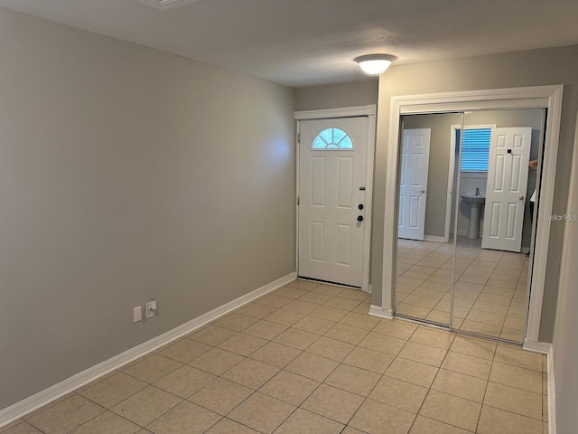 entrance foyer featuring light tile patterned floors and a textured ceiling