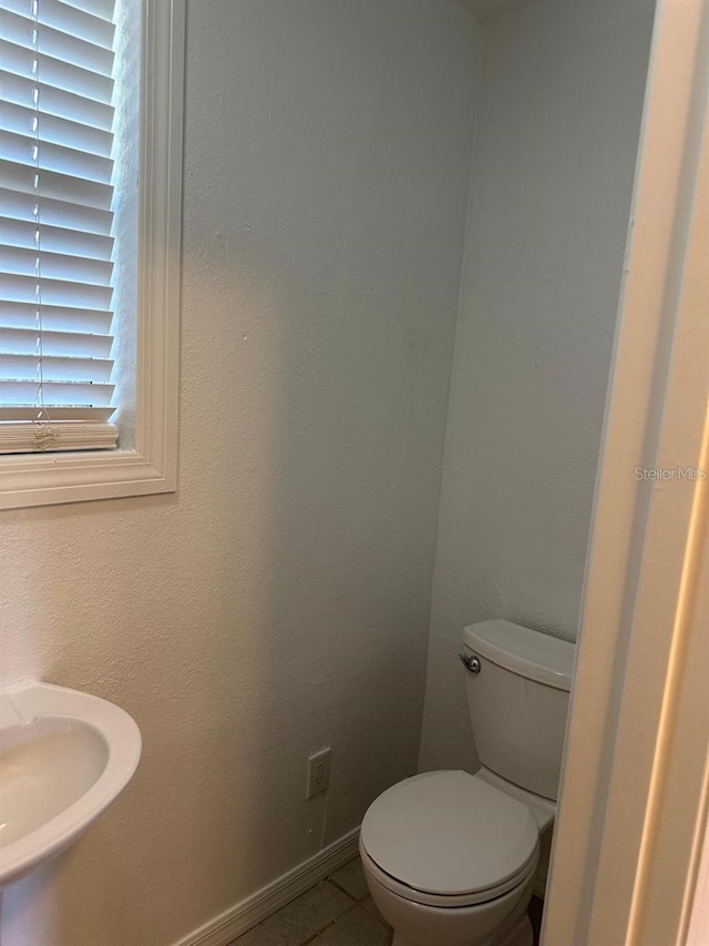 bathroom with tile patterned flooring and toilet