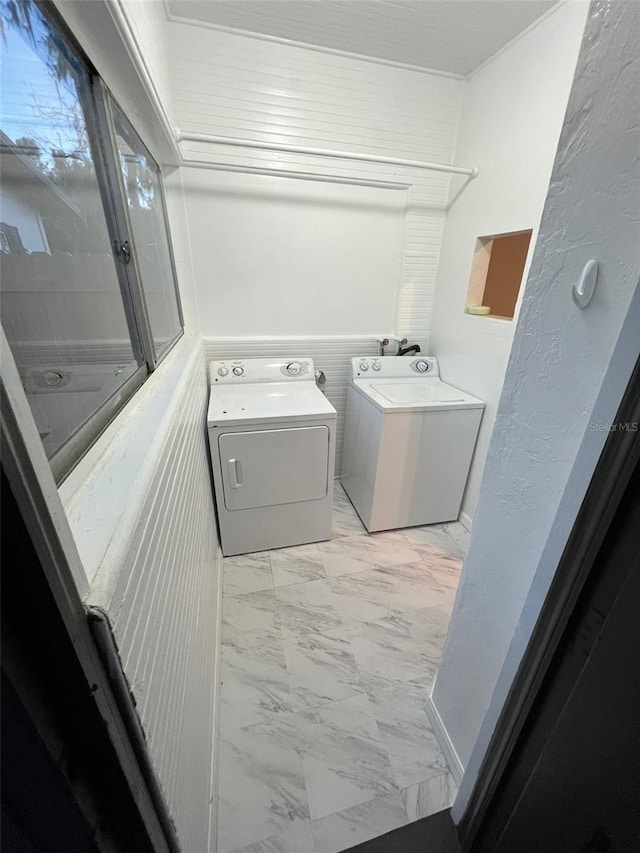 clothes washing area featuring separate washer and dryer