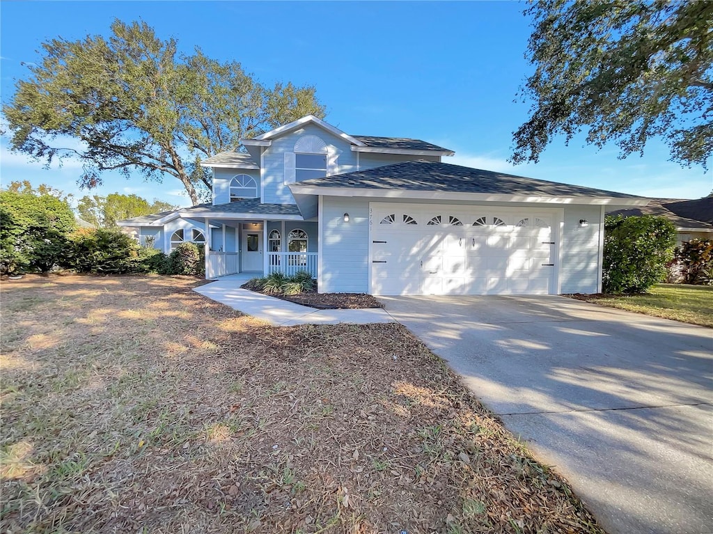 view of front of property with covered porch and a garage