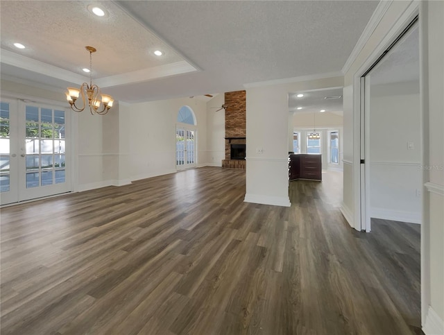 unfurnished living room featuring a textured ceiling, plenty of natural light, and dark wood-type flooring