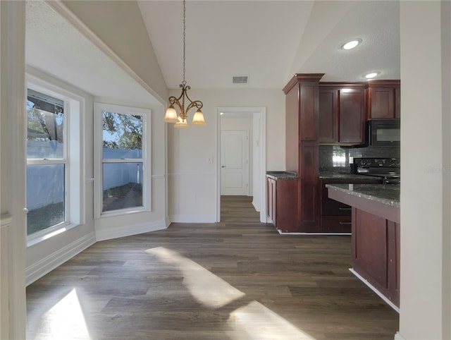 kitchen with dark hardwood / wood-style flooring, decorative light fixtures, plenty of natural light, and lofted ceiling