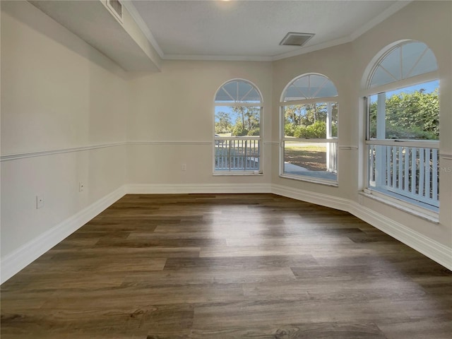 empty room with ornamental molding and dark wood-type flooring