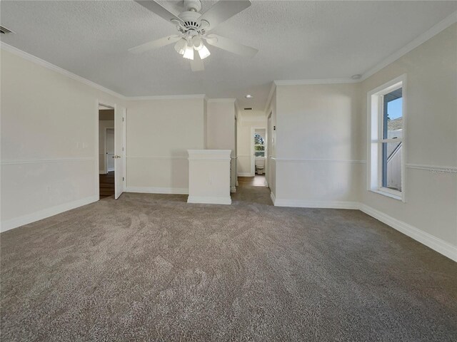 spare room featuring crown molding, ceiling fan, a textured ceiling, and dark colored carpet