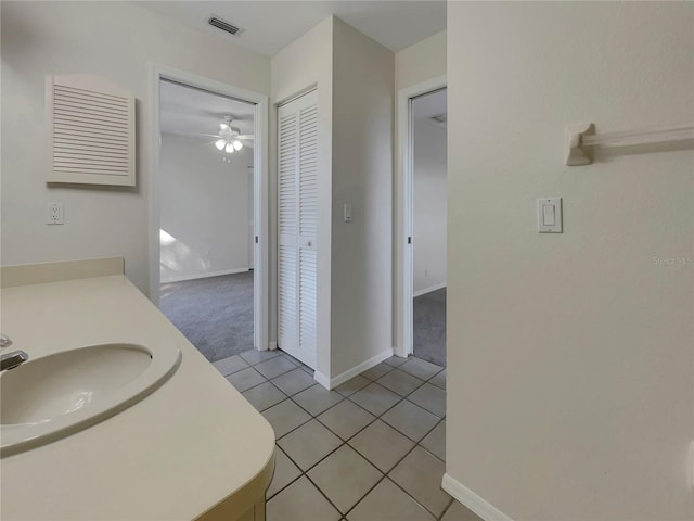 bathroom featuring tile patterned floors, ceiling fan, and sink