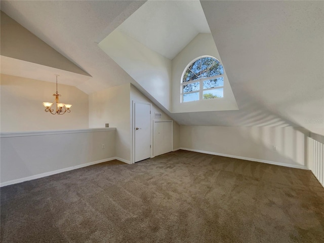 additional living space featuring dark colored carpet, lofted ceiling, and a chandelier