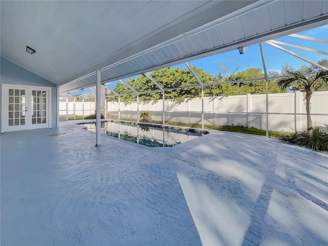 view of swimming pool featuring french doors, a patio area, and a lanai