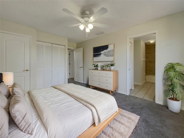 bedroom featuring carpet, a textured ceiling, connected bathroom, and ceiling fan