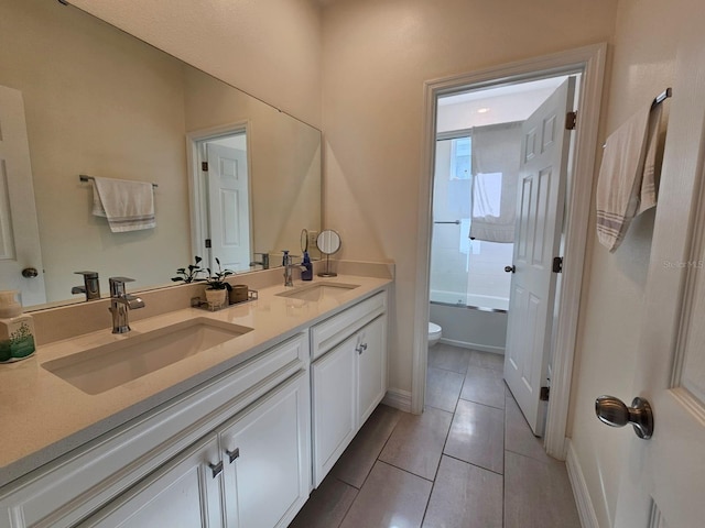 full bathroom featuring tile patterned flooring, toilet, vanity, and combined bath / shower with glass door