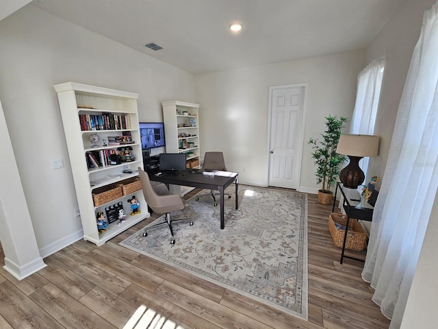 home office with light hardwood / wood-style floors