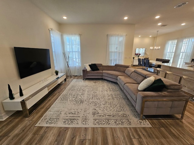 living room featuring dark hardwood / wood-style floors and a notable chandelier