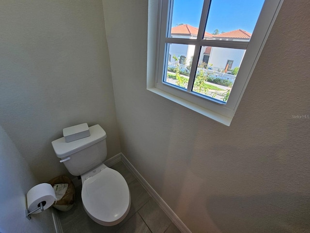 bathroom featuring tile patterned flooring and toilet