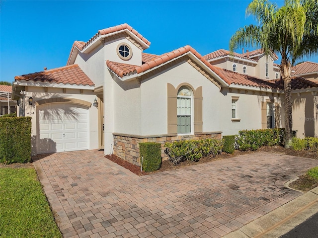 mediterranean / spanish house featuring a garage