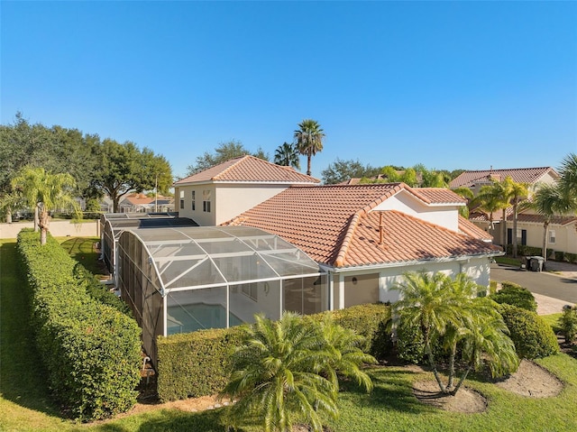 rear view of property featuring a lanai