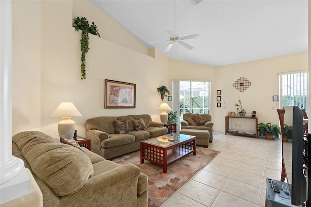 tiled living room with ceiling fan and lofted ceiling