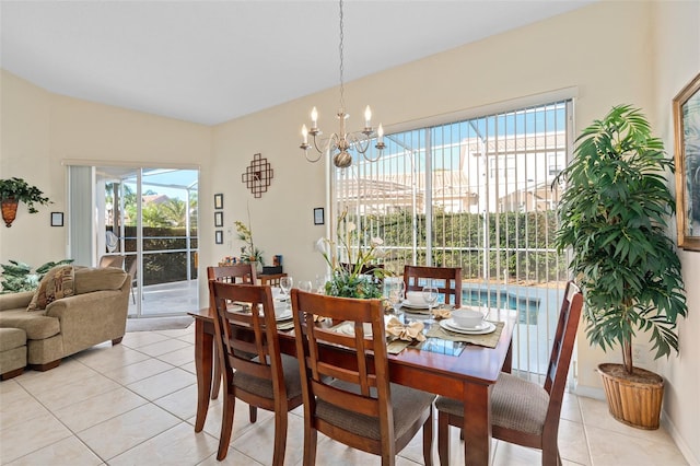 dining area featuring light tile patterned flooring and an inviting chandelier