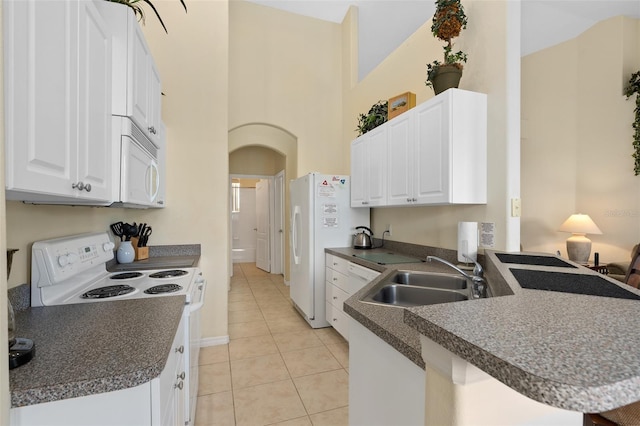 kitchen with kitchen peninsula, sink, white cabinets, and white appliances