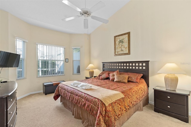 bedroom featuring ceiling fan, light colored carpet, and lofted ceiling