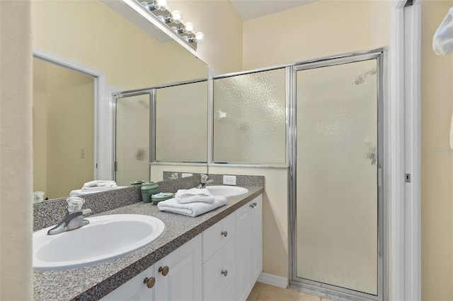 bathroom with tile patterned flooring, vanity, and an enclosed shower