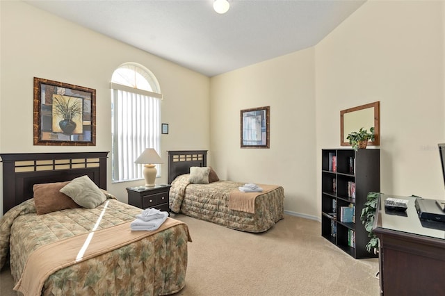 carpeted bedroom featuring vaulted ceiling