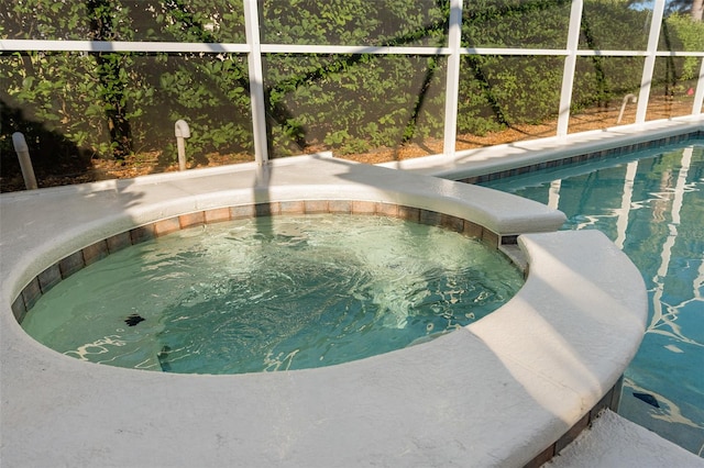 view of swimming pool featuring an in ground hot tub