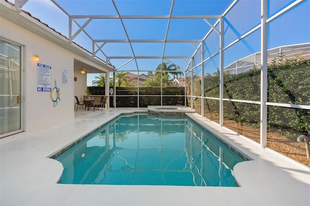 view of swimming pool featuring a lanai, an in ground hot tub, and a patio