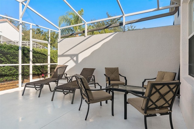 view of patio / terrace featuring glass enclosure