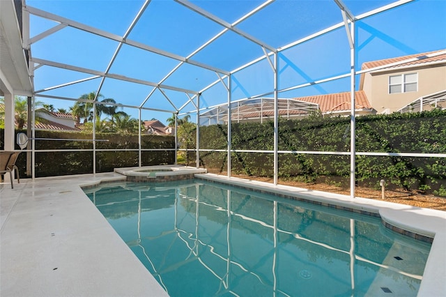 view of swimming pool featuring a lanai, an in ground hot tub, and a patio