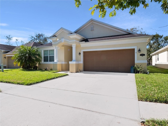 view of front of home with a garage and a front lawn