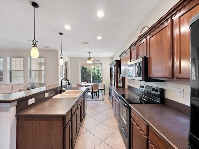 kitchen with sink, ceiling fan, a textured ceiling, appliances with stainless steel finishes, and decorative light fixtures